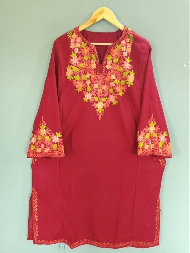 A traditional Kashmiri embroidered pheran in red with intricate floral patterns, displayed on a mannequin.